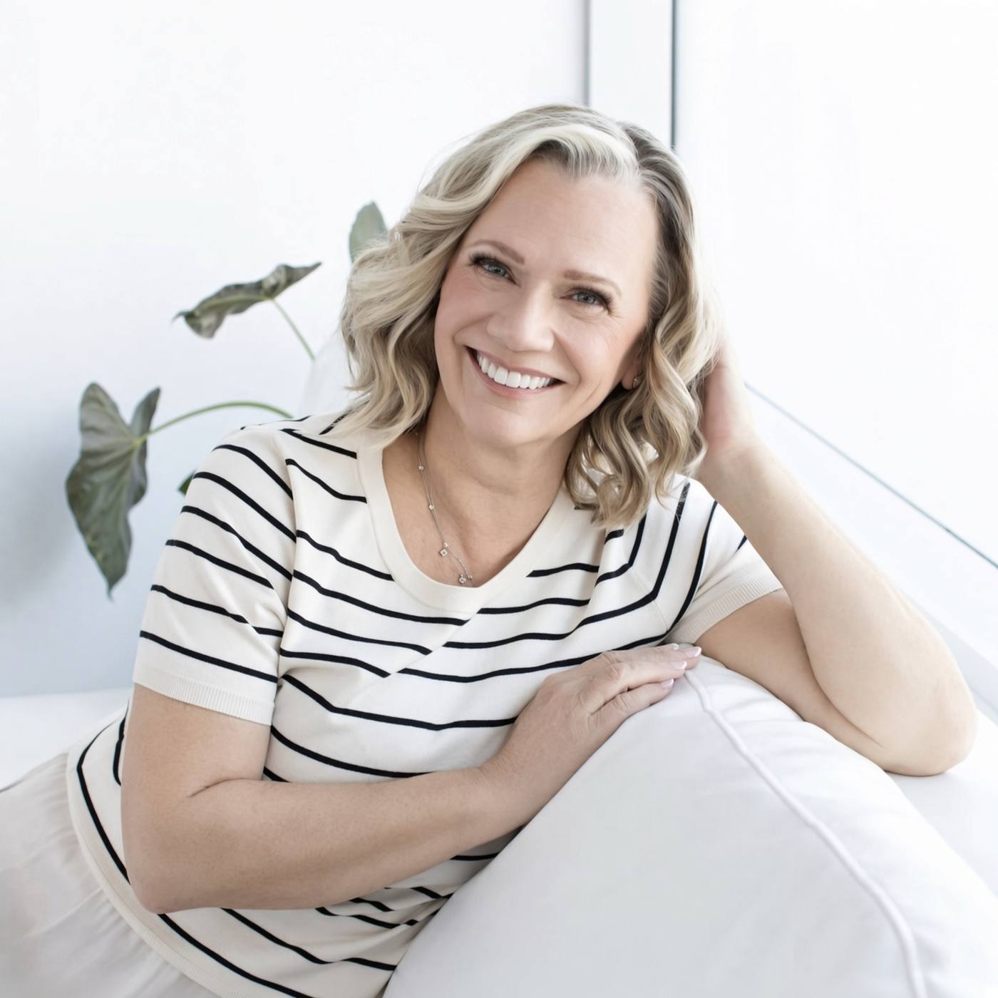 Louisa Chiaramonte, smiling, in a cream striped top